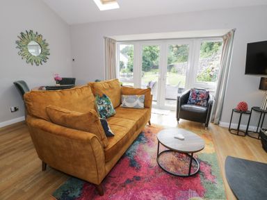 A living room with a sofa and coffee table at Pengwern Bach Llanrwst