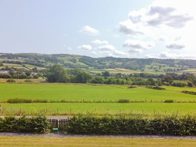 A view of fields and hills at Pengwern Bach in Llanrwst