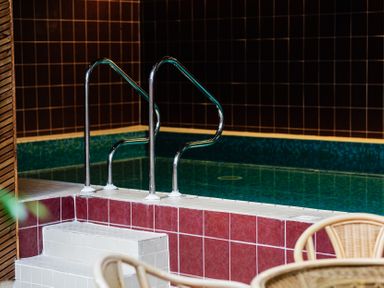 An indoor pool area with steps and handrail at Rose Cottage in Akeld near Wooler