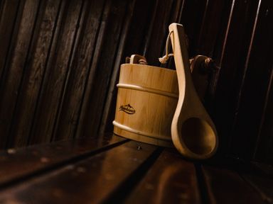 A wooden bucket and ladle in a sauna at Rose Cottage Akeld near Wooler