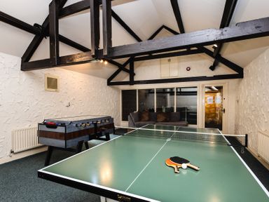 A game room with a table tennis table and foosball table at Rose Cottage Akeld near Wooler