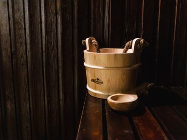 A wooden bucket and scoop on a table at Lupin Cottage Akeld near Wooler
