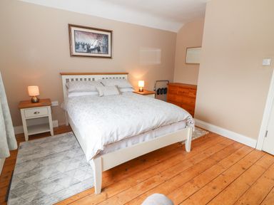 A bedroom with a bed and side tables with lamps and a wooden dresser at 17 Clover Hill in Killorglin County Kerry