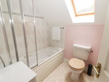 A bathroom with a bathtub shower toilet and a skylight window at 17 Clover Hill in Killorglin County Kerry