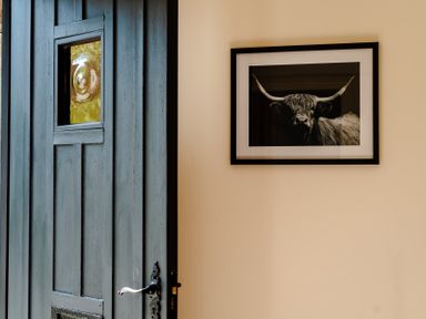 An entrance with a door and a framed picture at Bramble Cottage in Akeld near Wooler