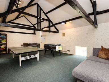 A recreation room with a ping pong table and foosball table at Tile Rouge in Wooler