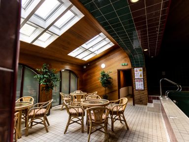 A room with tables and chairs in a pool area at Catkin Cottage Akeld near Wooler
