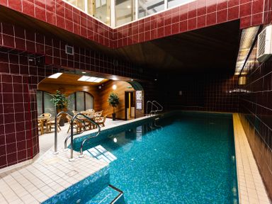 An indoor pool area with a swimming pool and seating at The Columbine in Akeld near Wooler