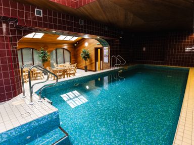 An indoor pool with seating area at The Columbine in Akeld near Wooler