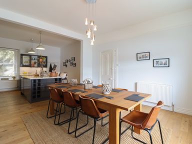 A dining room with a table and chairs at 5 Porkington Terrace in Barmouth