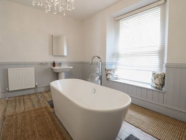 A bathroom with a bathtub and sink at 5 Porkington Terrace in Barmouth