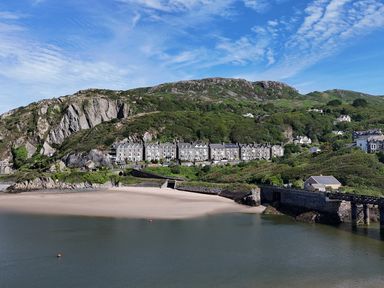 A beach with hotel buildings beside water at 5 Porkington Terrace Barmouth