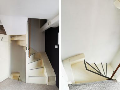 A narrow staircase with white walls and a wooden handrail at Kooky Cottage in Brecon
