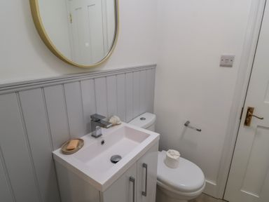 A bathroom with a sink and toilet at Still Waters in Swanage
