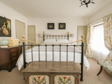 A bedroom with a bed and a chest at the foot at Norden House in Maiden Newton