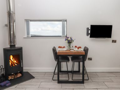 A dining area with a table and chairs at The Cadeleigh near Tiverton