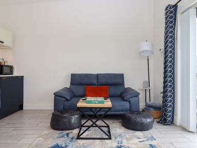 A living room with a sofa and table at The Cadeleigh near Tiverton