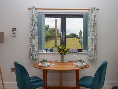 A dining room with a table and chairs at The Pennymoor in Cadeleigh near Tiverton