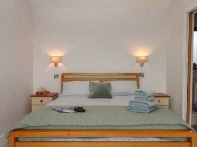A bedroom with a bed and towels at The Pennymoor in Cadeleigh near Tiverton