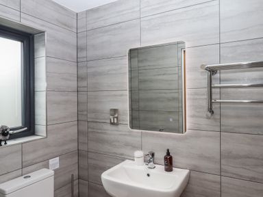 A bathroom with a sink and a mirror at The Pennymoor in Cadeleigh near Tiverton