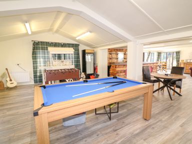 A game room with a pool table foosball table guitar and seating area at Silver Birch Lodge in Misterton