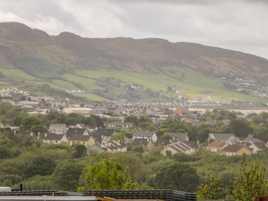 A town with houses and trees with hills in the background at Wee Andy's in Slavary near Buncrana County Donegal