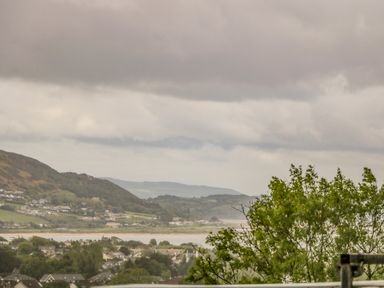 A view of a town with houses trees hills and a body of water at Wee Andy's Slavary near Buncrana County Donegal