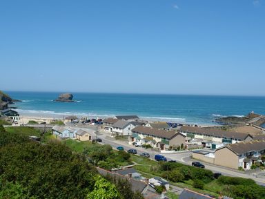 A coastal town with houses roads and a beach next to the ocean at Byghan Thornton in Illogan