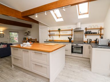 A kitchen with an island and skylights at Bridgend Cottages in Howey near Llandrindod Wells