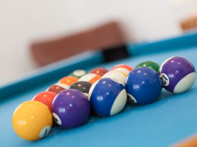 A set of billiard balls arranged on a blue pool table at Whitsunday House in Carbis Bay