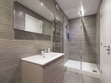 A bathroom with a sink vanity and a walk in shower at Atlantic Watch 8 in Carbis Bay
