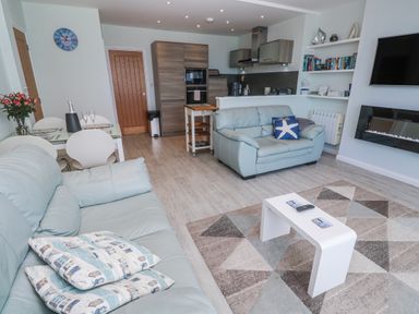A living room with a kitchen area at Island View in Carbis Bay