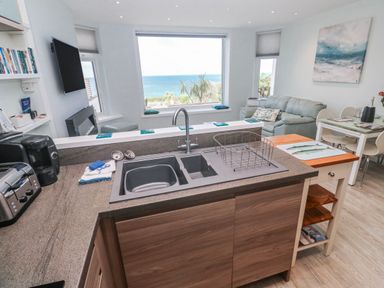 A kitchen with a sink and appliances at Island View in Carbis Bay