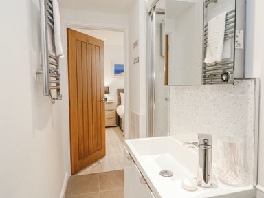 A bathroom with a sink and mirror at Island View in Carbis Bay