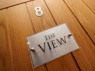 A wooden door with a number 8 and a sign that reads The View at The View in St Ives