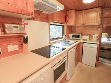 A kitchen with appliances and countertop at Squirrels Leap Number 29, Burnside Park near Keswick