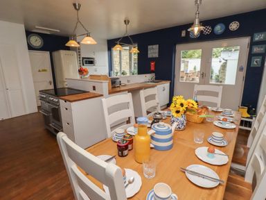 A kitchen with a dining table and chairs at ASTA COTTAGE in Cresswell