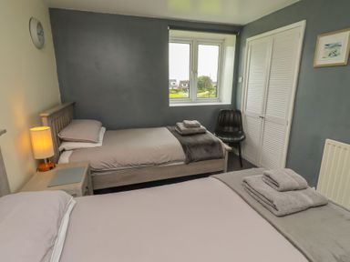 A bedroom with two beds and a window at ASTA COTTAGE Cresswell