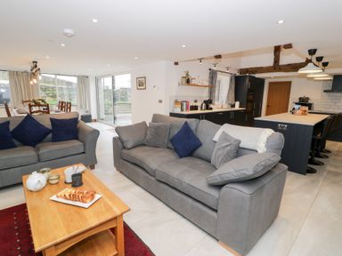 A living room with a sofa and a coffee table at Merddwr in Cerrigydrudion