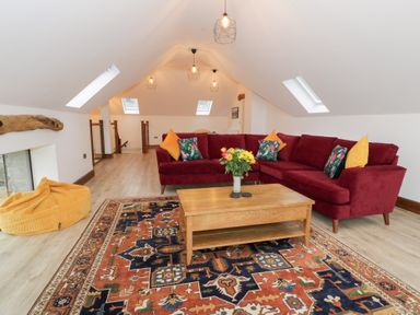 A living room with a sofa and coffee table at Merddwr in Cerrigydrudion