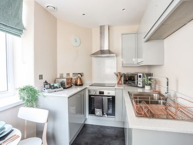 A kitchen with a stove oven microwave sink and toaster at Nantlle in Caernarfon