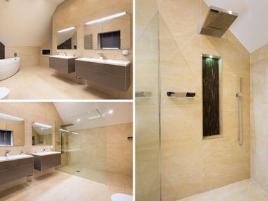 A bathroom with double sinks a walk-in shower and a bathtub at Carus House at Carus Green Golf Club Kendal