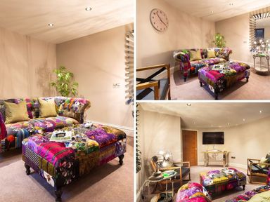 A sitting room with a patchwork sofa and ottoman two wooden armchairs a wall clock a TV and a small plant at Carus House at Carus Green Golf Club Kendal