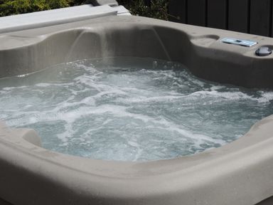 An outdoor jacuzzi with bubbling water and a control panel at 26 Hycemoor Way Bootle Near Millom