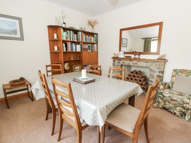 A dining room with a table and chairs at Kala in Spittal near Haverfordwest