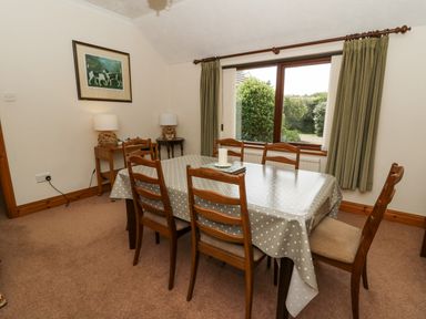 A dining room with a table and chairs at Kala in Spittal near Haverfordwest