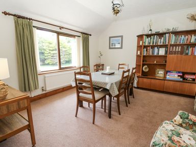 A dining room with a table and chairs at Kala in Spittal near Haverfordwest
