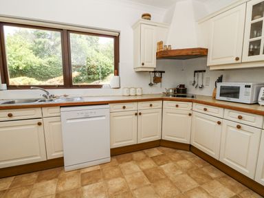 A kitchen with cabinets and appliances at Kala in Spittal near Haverfordwest