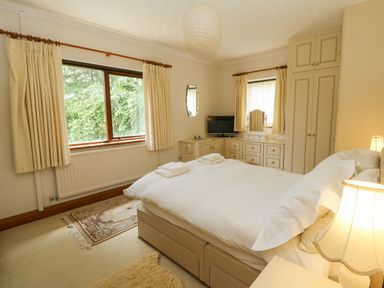A bedroom with a bed and a television at Kala in Spittal near Haverfordwest