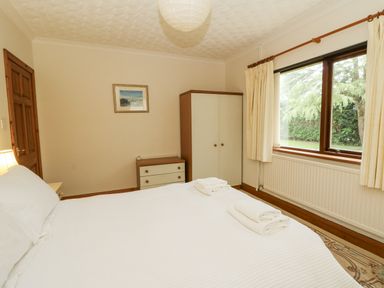 A bedroom with a bed and a wardrobe at Kala in Spittal near Haverfordwest